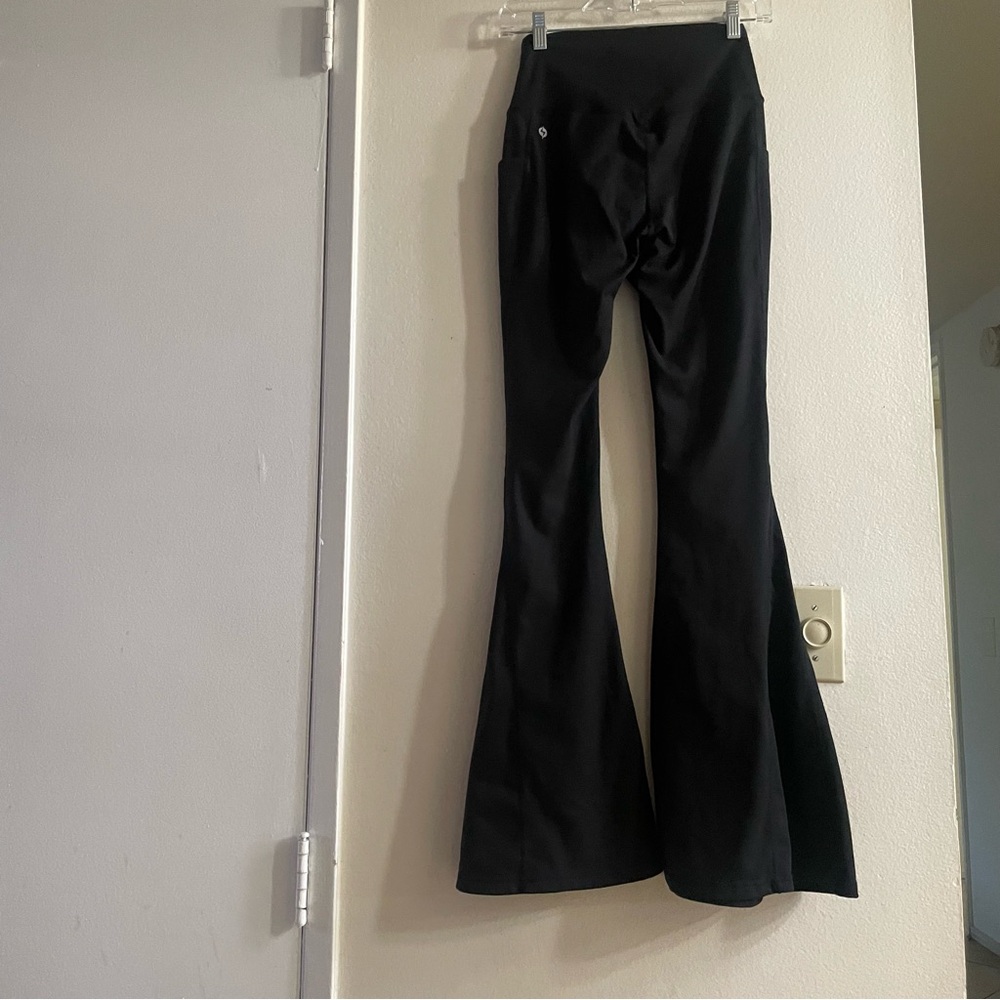 Popflex black bell bottom 31” crisscross waist leggings size small